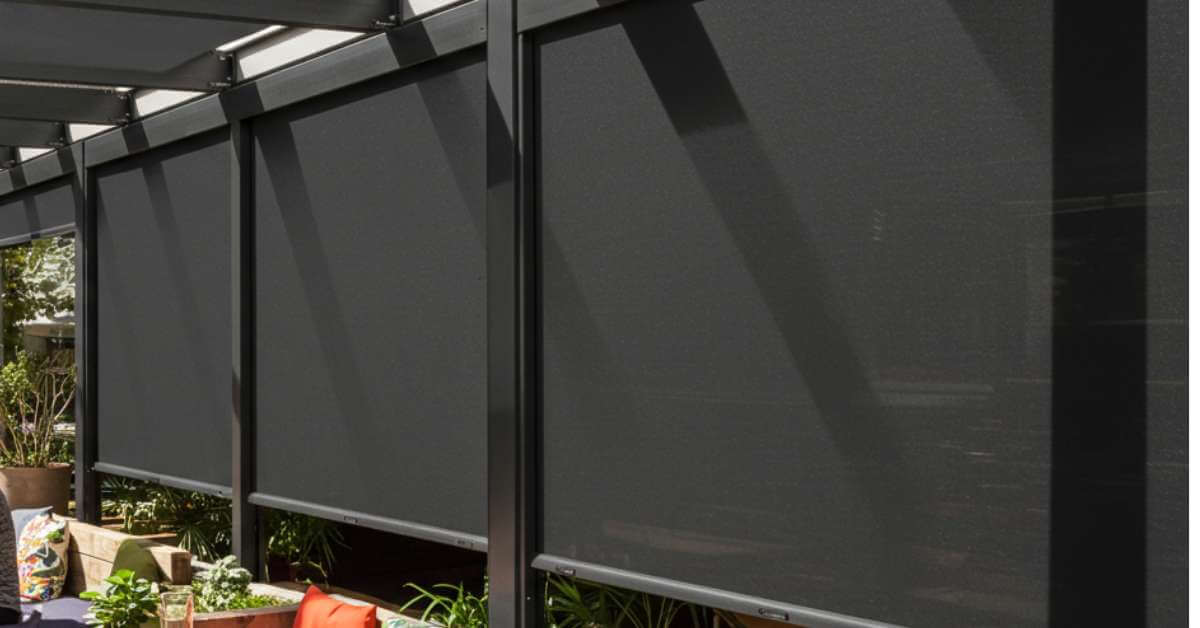 this is a picture of a drop shades that can be custom-made to fit unique layouts, widths, and heights, making them ideal for patios, balconies of restaurants